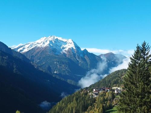 a snow covered mountain with a town in a valley at Apart Anna & Anton in Brandberg