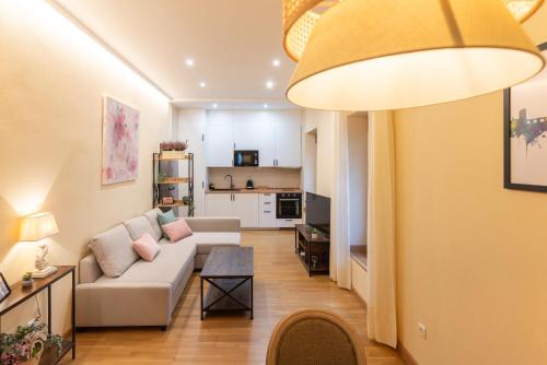 a living room with a couch and a table at APARTAMENTO PUERTA DE CÓRDOBA Exterior con balcones in Córdoba