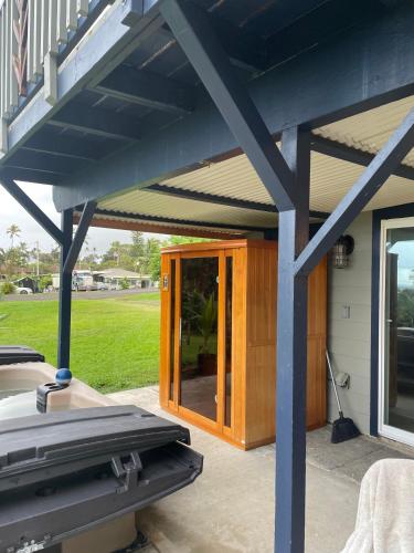a house with a porch with a glass door at Helehele Hale in Hana