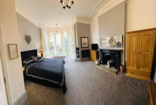 a bedroom with a bed and a fireplace at Luxury garden flat under the Castle in Kent