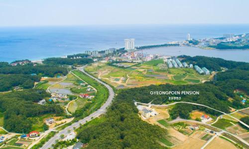 an aerial view of a park next to the ocean at Gyeongpoen Pension in Gangneung