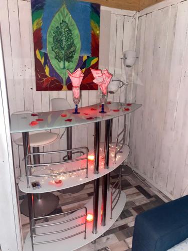 Habitación con 3 estanterías con gafas y luces en Romantic Woodhouse casita camping, en Aguatona