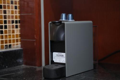 a soap dispenser sitting on a counter in a bathroom at Luxurious apartment - New Cairo in Cairo