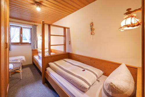a bedroom with a bunk bed and a ladder at Oberaschenauer-Hof in Ruhpolding
