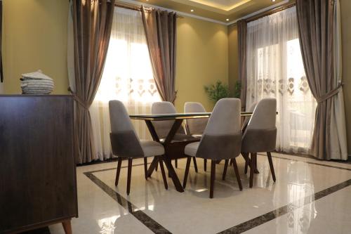 a dining room with a table and chairs at Luxurious apartment - New Cairo in Cairo
