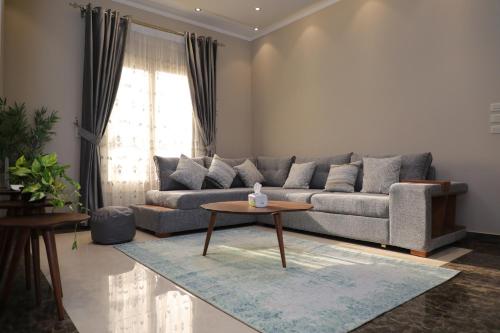 a living room with a couch and a table at Luxurious apartment - New Cairo in Cairo