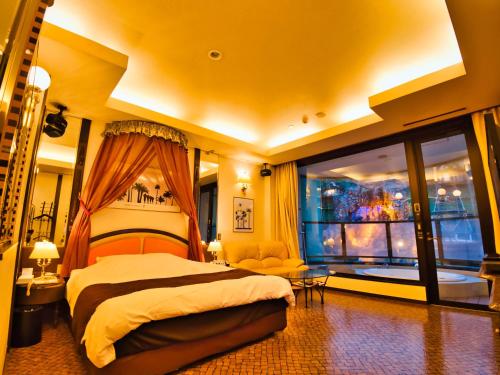 a bedroom with a bed and a large window at SKY PARADISE スカイパラダイス　ラクエン in Oita