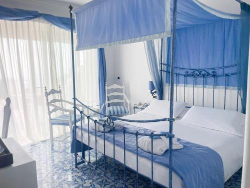 a bedroom with two bunk beds and blue curtains at Regina Cristina in Capri
