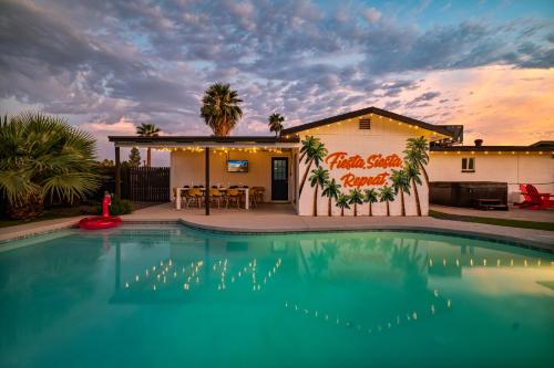 a house with a swimming pool in front of a building at Gorgeous 4-bed home with Golf, Pool, & Hot Tub! in Phoenix