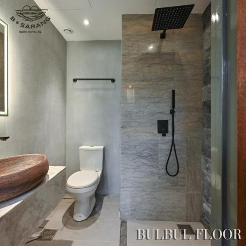 a bathroom with a toilet and a shower at B Sarang Suite Hotel Kuala Lumpur in Kuala Lumpur