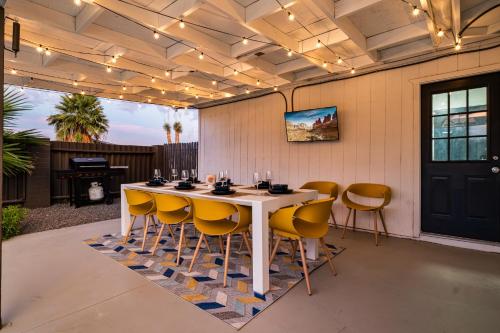 a dining room with a table and yellow chairs at Gorgeous 4-bed home with Golf, Pool, & Hot Tub! in Phoenix