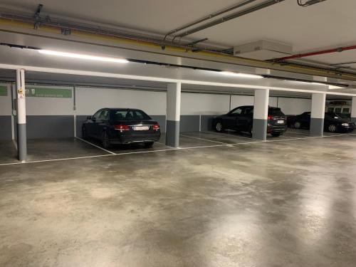 a parking garage with two cars parked in it at Logies Ternier in Nieuwpoort