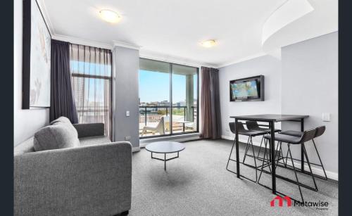 a living room with a couch and a table at MetaWise Sydney CBD Haymarket 2Bed Apartment 1506 in Sydney