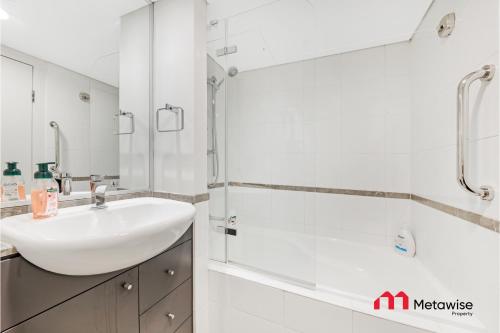 a white bathroom with a sink and a shower at MetaWise Sydney CBD Haymarket 2Bed Apartment 1506 in Sydney