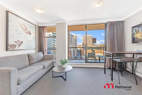 a living room with a couch and a table at MetaWise Sydney CBD Haymarket 2Bed Apartment 1506 in Sydney