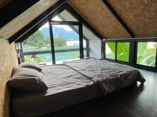 a large bed in a room with a large window at Phi Phi Goodview Bungalow in Phi Phi Don