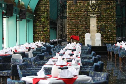 a row of tables and chairs in a building at Ramada by Wyndham Manama City Centre in Manama
