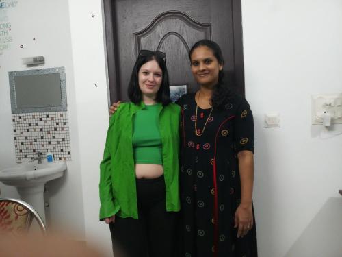 two women standing next to each other in a bathroom at PRAKRITI HOMESTAY Fortkochi Air Conditioned Rooms in Cochin