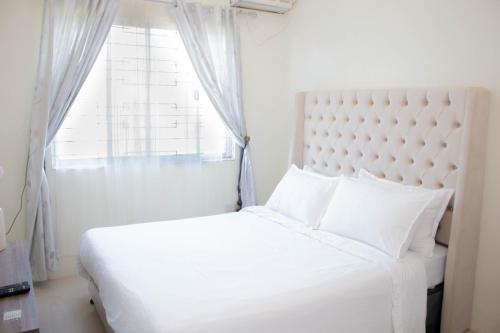 Postel nebo postele na pokoji v ubytování Vitasolo Hometel & Suite