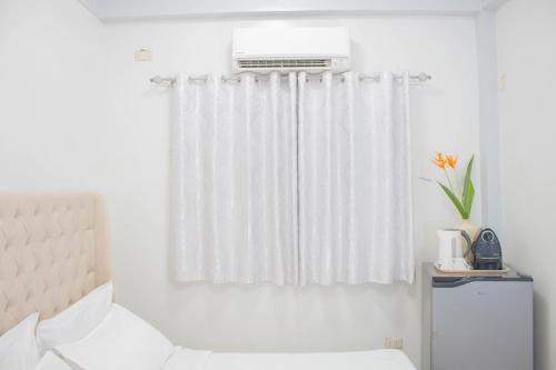 Postel nebo postele na pokoji v ubytování Vitasolo Hometel & Suite
