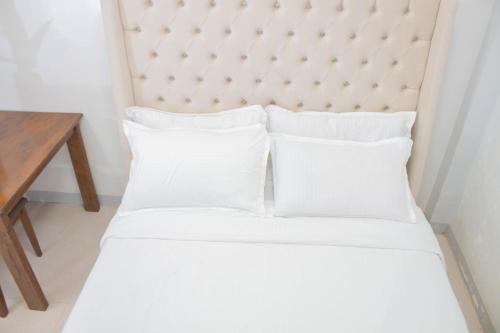 Postel nebo postele na pokoji v ubytování Vitasolo Hometel & Suite