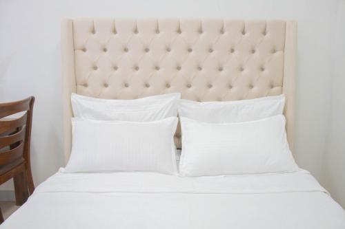 Postel nebo postele na pokoji v ubytování Vitasolo Hometel & Suite