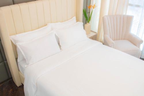 Postel nebo postele na pokoji v ubytování Vitasolo Hometel & Suite
