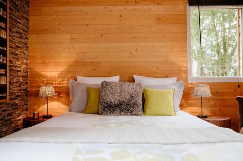 a bedroom with a white bed with two lamps at Le Clos De La Roche in Goven