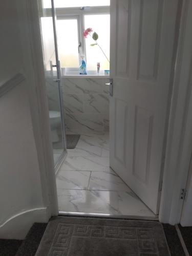 an open door to a bathroom with a tile floor at Fresher Space Home Stay in Birmingham