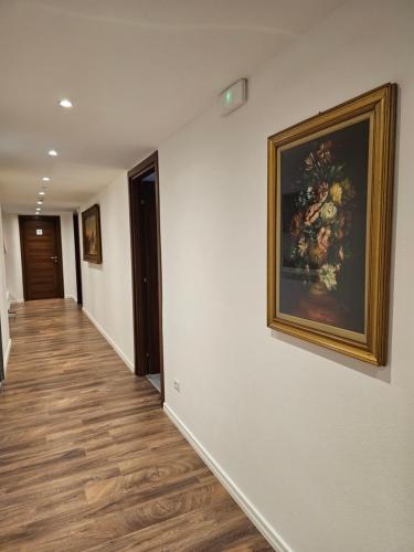 a hallway with a painting of flowers on the wall at Victoria Royal Garden in Como
