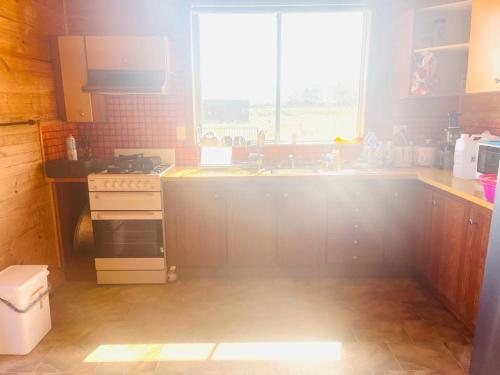 a kitchen with a sink and a window at Ross Creek farm Stay in Ross Creek