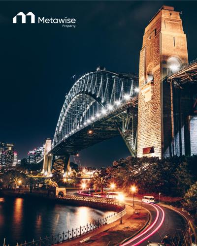 a sydney harbour bridge lit up at night at MetaWise Sydney CBD Luxury City view 2BED Apartment in Sydney