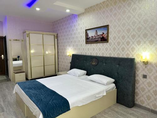 a bedroom with a large bed in a room at Starway Hotel in Lankaran
