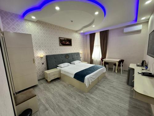a hotel room with a bed with a blue lighting at Starway Hotel in Lankaran