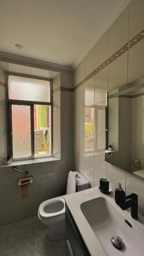 a bathroom with a white toilet and a sink at La Pita Beach house in Almería