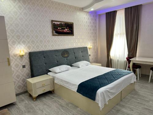 a bedroom with a large bed in a room at Starway Hotel in Lankaran