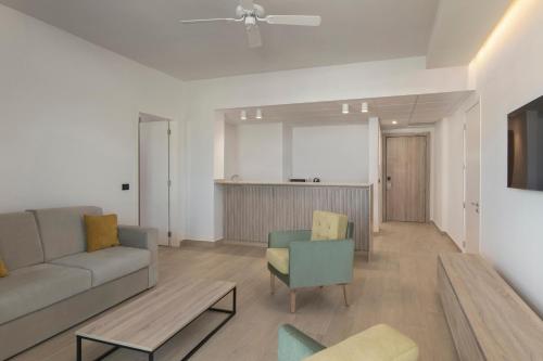 a living room with a couch and chairs at Serenade All Suites - Adults Only Resort in Punta Cana