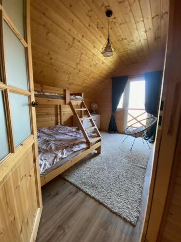 a room with a bunk bed and a window at Sielanka Mazurska Świętajno Aprt 1 in Świętajno