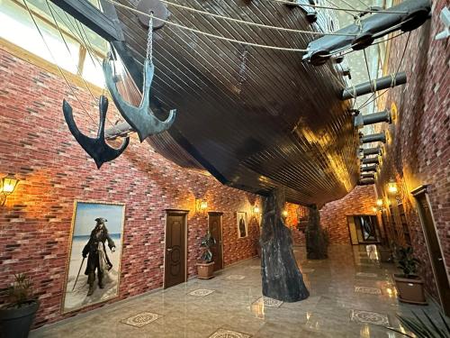 a large boat hanging from the ceiling of a building at Starway Hotel in Lankaran