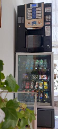 a refrigerator with food inside of it next to a microwave at Nonna Anita Palace Narni in Narni