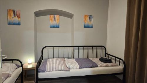 a bed in a bedroom with two paintings on the wall at APARTMENTS KREMSTAL in Imbach