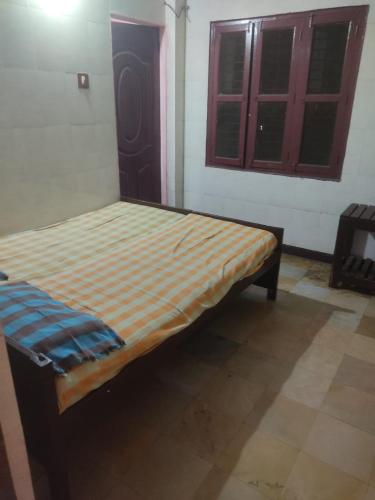 a small bed in a room with a window at G R MANSION in Vellore