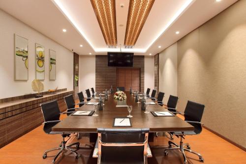 a large conference room with a long table and chairs at Distrikt 9 in Palakkad