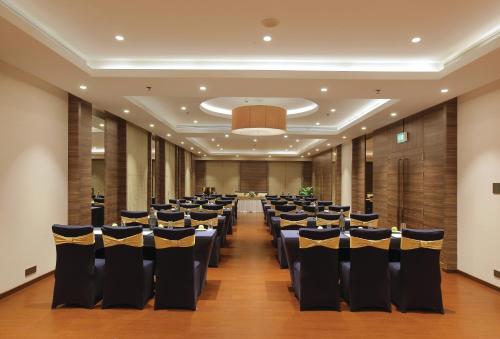 a room with rows of chairs in a hall at Distrikt 9 in Palakkad