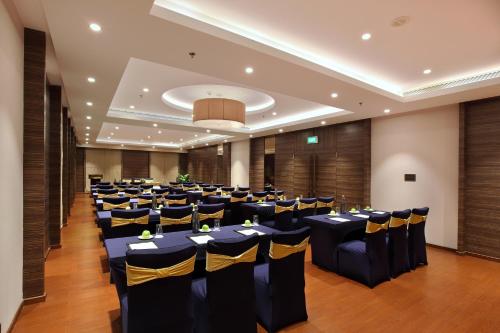 a banquet hall with tables and chairs in a room at Distrikt 9 in Palakkad