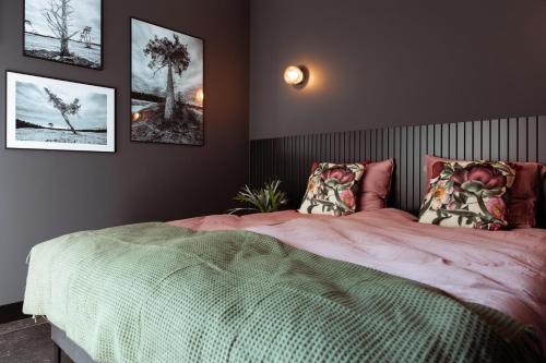 a bedroom with a large bed with two pillows at B en B De Jufferswaard in Renkum