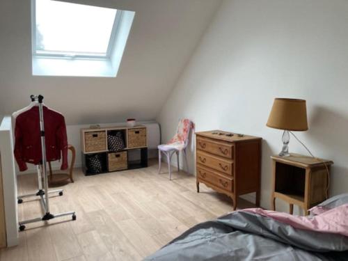 a bedroom with a bed and a desk and a window at La maison du Cèdre in Châteauneuf-Val-de-Bargis