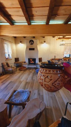 a living room with a large vase and a fireplace at Cuibul Braneanului in Bran