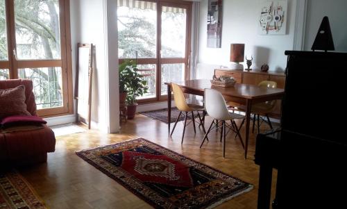 a living room with a dining room table and chairs at Sunny Private Bedrooms in Peaceful Shared Flat near Bois de Vincennes in Fontenay-sous-Bois