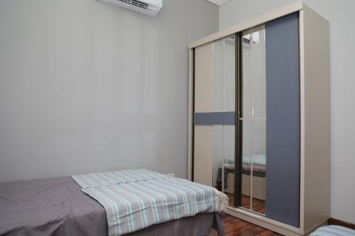 a bedroom with a bed and a glass closet at Luxurious apartment - New Cairo in Cairo